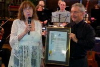 Board member Nancy Dunetz presents Mike with the framed proclamation.