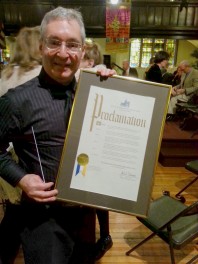 Music Director and orchestra founder Mike Tietz shows off the official proclamation.